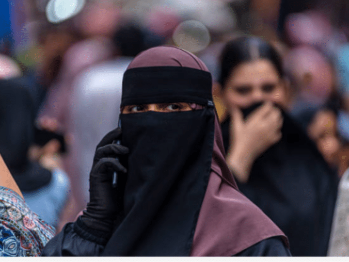 A Kashmiri Muslim woman speaks on her mobile phone in a market, ahead of Eid al-Adha, one of the most important festivals in Islam on May 25, 2026 in Srinagar, India.