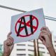 Hands holding a placard with AI crossed out SAG-AFTRA and Equity AI campaigns