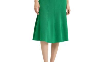 A woman wearing a bright green skirt and black slingbacks
