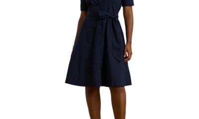A woman wearing a navy dress and brown heels