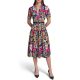 A woman wearing a colorful floral dress and black heels
