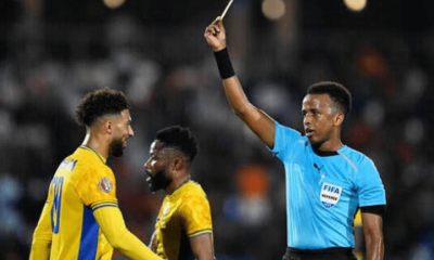 Gabon's forward #20 Denis Bouanga is shown the yellow card by Somali referee Omar Abdulkadir Artan during the Africa Cup of Nations (CAN) Group F football match between Gabon and Ivory Coast at the Grand Stadium in Marrakech on December 31, 2025. (Photo by Khaled DESOUKI / AFP via Getty Images)