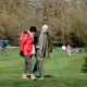 Carers Week: An older pair, one with two crutches, and the other locking their arm, walk and enjoy the spring sunshine at Mottisfont one of the National Trust parklands on 21 March 2020 in Romsey, UK