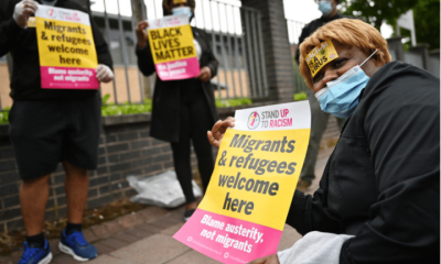 Protesters join a 'Refugees Lives Matter' protest on July 1, 2020 in Glasgow, Scotland. They are holding posters saying: 'Migrants and Refugees welcome here - Blame austerity not migrants'. The crisis in social care will worsen if sponsored workers are further forced to leave