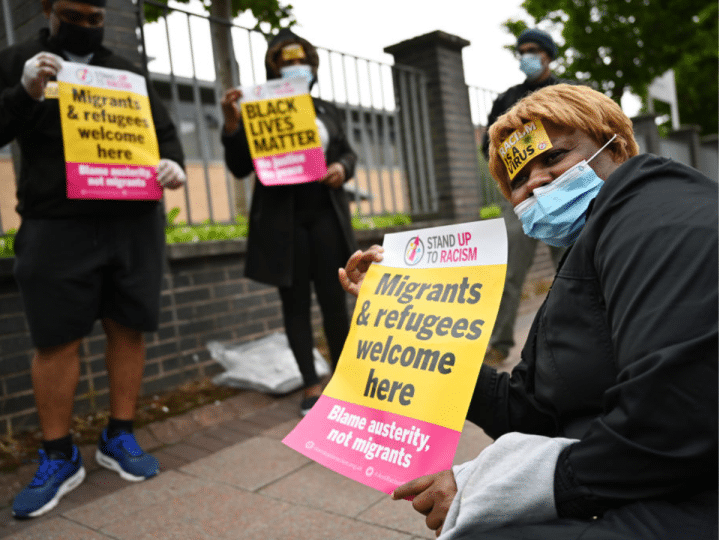 Protesters join a 'Refugees Lives Matter' protest on July 1, 2020 in Glasgow, Scotland. They are holding posters saying: 'Migrants and Refugees welcome here - Blame austerity not migrants'. The crisis in social care will worsen if sponsored workers are further forced to leave