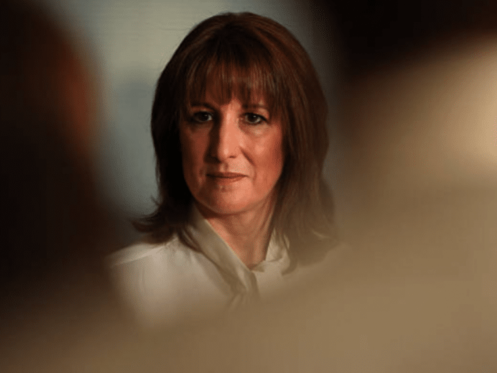 Rachel Reeves looks into the distance looking confident with a shadowy, blurred effect around the edges of the photo