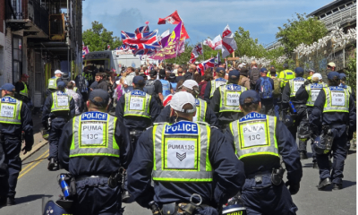 Police from Sussex follow behind protestors raising flags at a protest in Brighton which led to Ryan Bridge being arrested for common assault