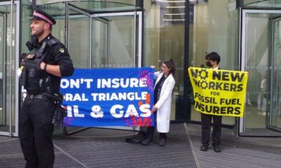 Protest at office of insurance company Swiss Re Banners say: Don't Insure Coral Triangle Oil & Gas No New Workers For Fossil Fuel Insurers