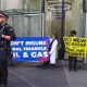 Protest at office of insurance company Swiss Re Banners say: Don't Insure Coral Triangle Oil & Gas No New Workers For Fossil Fuel Insurers