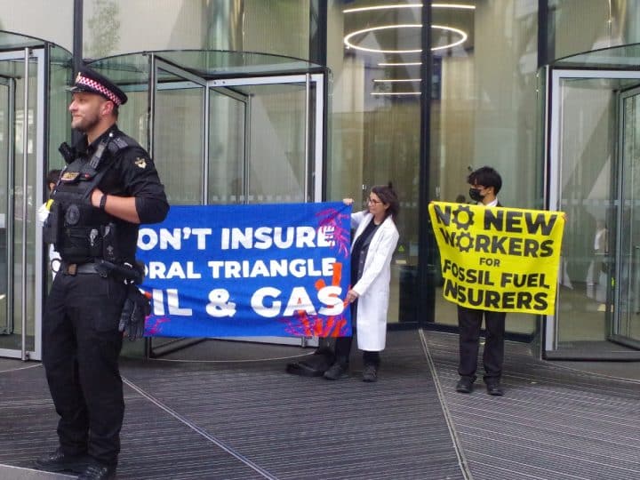 Protest at office of insurance company Swiss Re Banners say: Don't Insure Coral Triangle Oil & Gas No New Workers For Fossil Fuel Insurers
