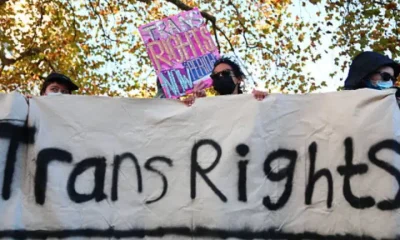 Trans rights activists hold placard