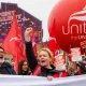 Unite members protest over Tata Steel with Sharon Graham up front, wearing a flourescent jacket and holding her fist in the air