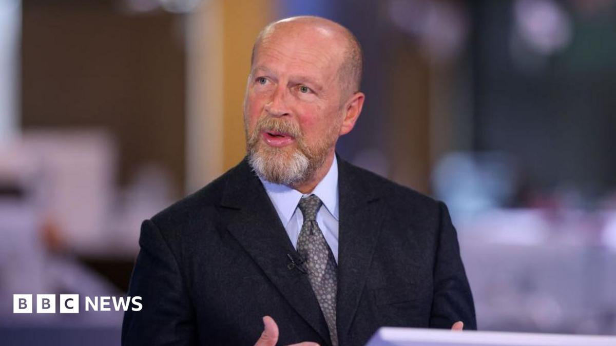 James Reed, chairman of Reed Executive Ltd., during a Bloomberg Television interview in London, UK in 2023. He is wearing a black suit jacket, a light coloured shirt with a grey and beige patterned tie.