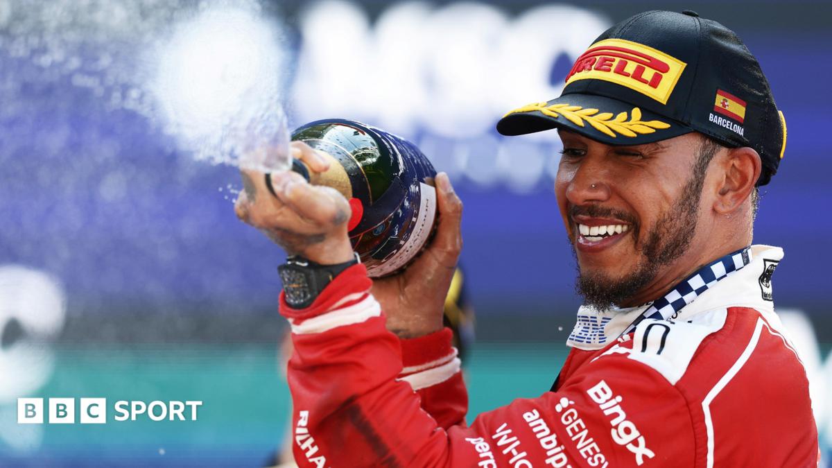 Lewis Hamilton crossing the line with Novak Djokovic waving the flag