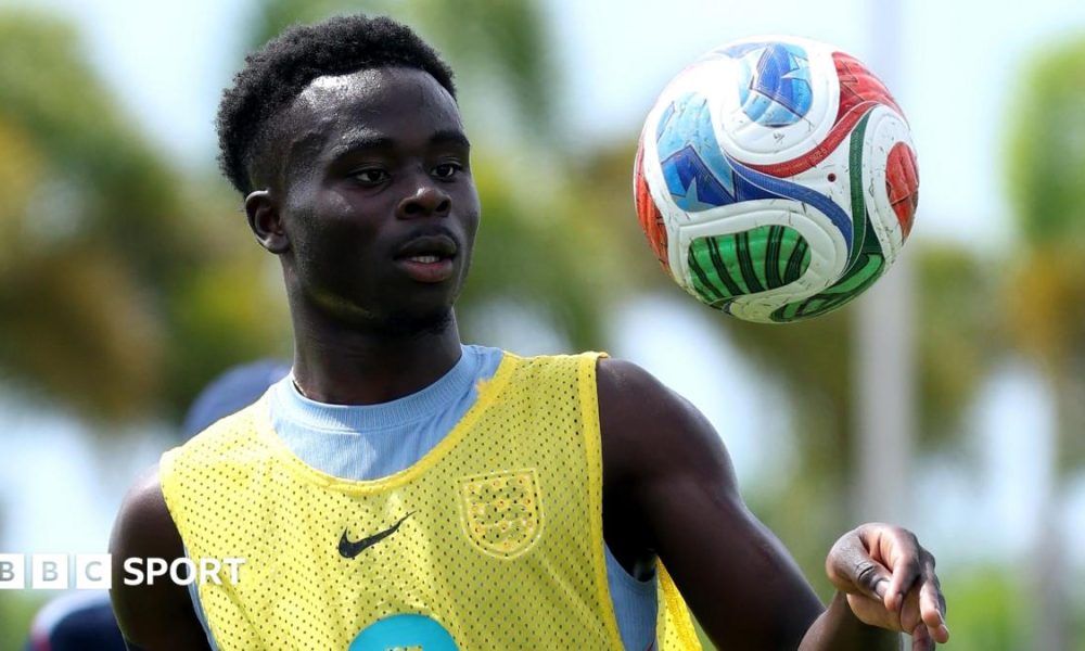 Bukayo Saka tosses a football in the air during an England training session in Florida