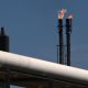 Shares reverse early losses as oil slide continues
