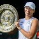 Iga Swiatek holding the Wimbledon women's singles final trophy
