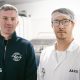 Kieran Woods is wearing a blue fleece with the Knob of Butter logo on it. He is standing next to Jules Bal who is   wearing a hair net, glasses and a white T-shirt with a white overall over it. It has the name Jules sewn into it.