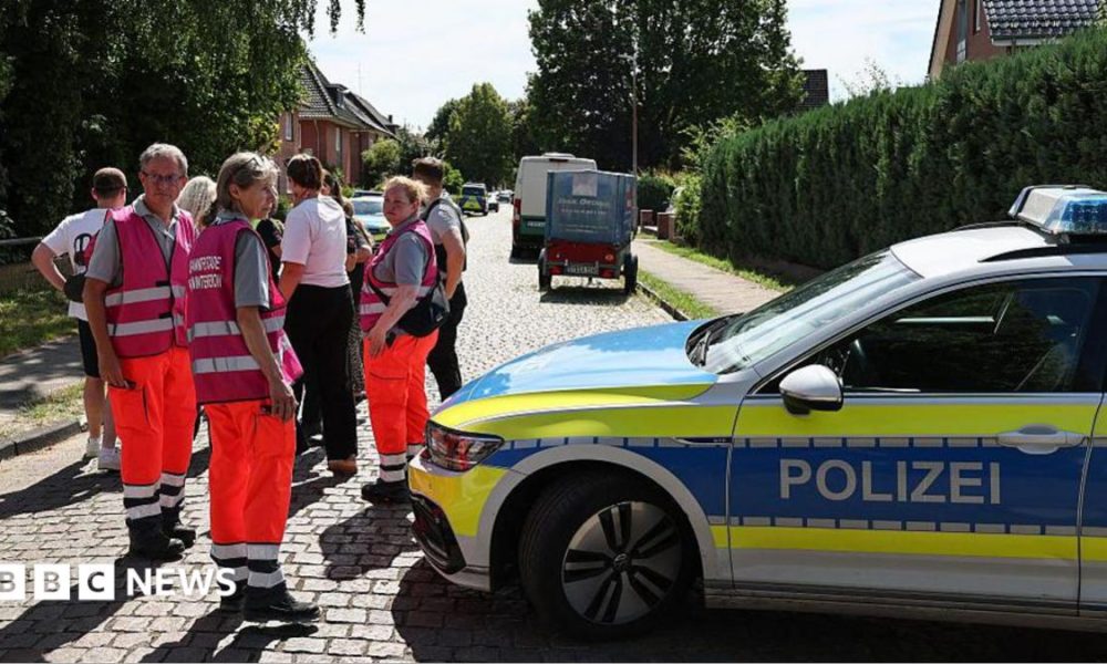 Police and members of a crisis intervention team speak to people near the scene where five people were killed in a shooting in Stade, northern Germany. Photo: 29 June 2026