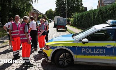 Police and members of a crisis intervention team speak to people near the scene where five people were killed in a shooting in Stade, northern Germany. Photo: 29 June 2026