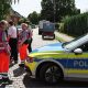 Police and members of a crisis intervention team speak to people near the scene where five people were killed in a shooting in Stade, northern Germany. Photo: 29 June 2026