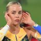 Keely Hodgkinson poses on a throne after breaking the world indoor 800m record
