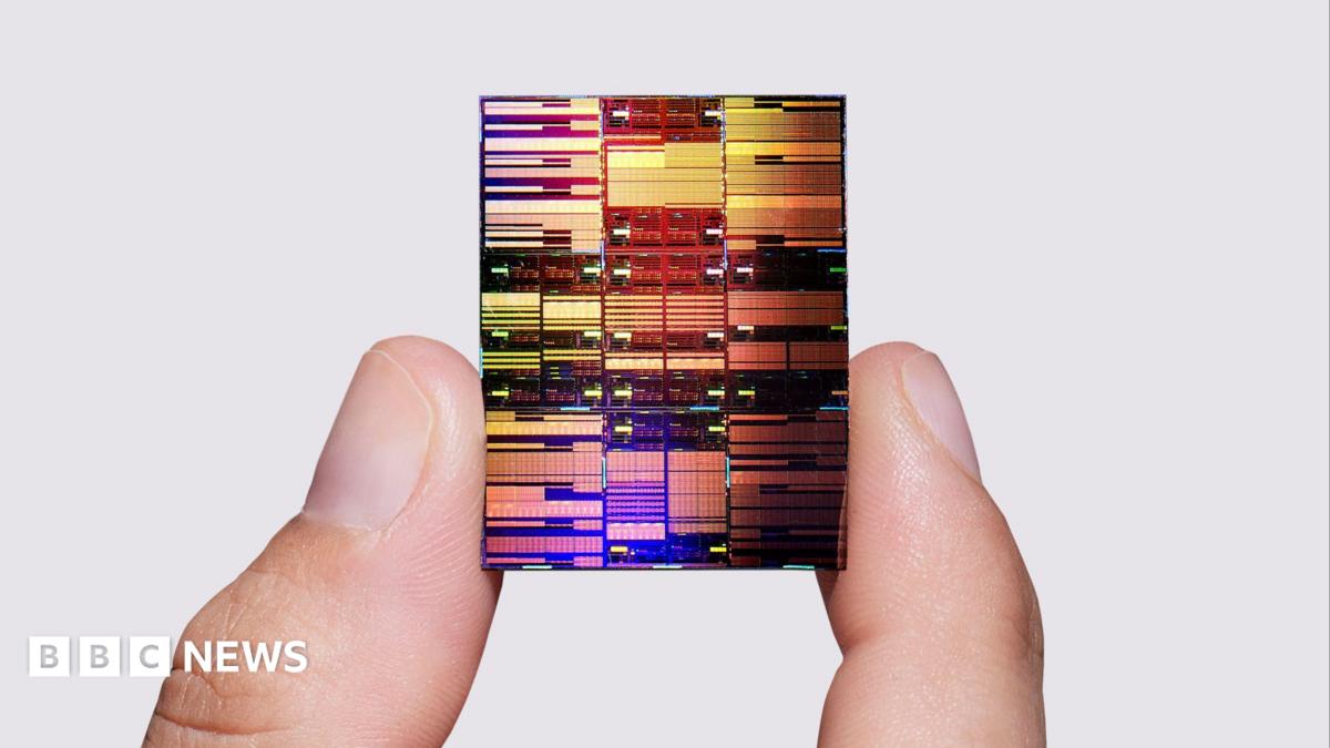 Researcher holding IBM's sub-1 nm node chip