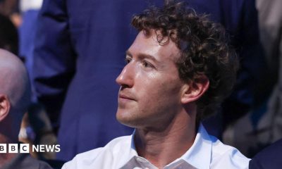 Mark Zuckerberg, wearing a white collared shirt while sitting in a crowd at the recent UFC event at the White House.