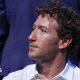 Mark Zuckerberg, wearing a white collared shirt while sitting in a crowd at the recent UFC event at the White House.