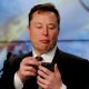 Elon Musk looks at his mobile phone