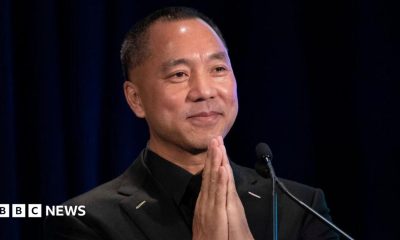 Chinese billionaire Guo Wengui places his hands together while speaking on stage during a news conference in 2018 in New York