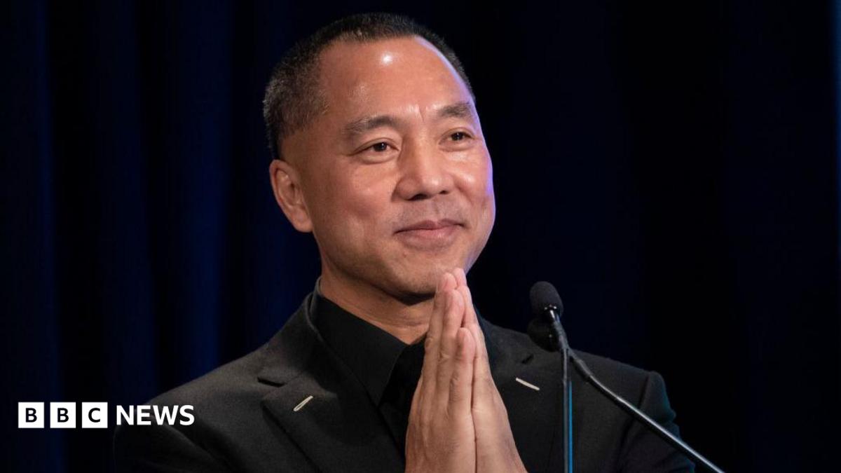 Chinese billionaire Guo Wengui places his hands together while speaking on stage during a news conference in 2018 in New York