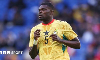 Thomas Partey running, wearing a yellow patterned Ghana shirt