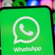 WhatsApp logo displayed on a smartphone screen, with its logo shown alongside those of Meta apps Facebook, Instagram and Threads.