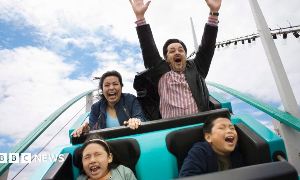 A stock image of a family enjoying a rollercoaster.