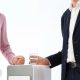 a group of colleagues gathers around the water cooler