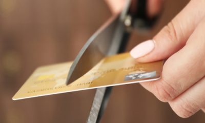 woman cuts a credit card in half