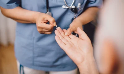 Midsection of nurse taking male patient