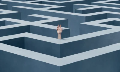 Hand reaching out from inside a giant maze, concept of confusion, struggle, help, mental exhaustion, problem solving and stress, 3d render