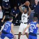 Kawhi Leonard #2 of the LA Clippers looks for help as he is defended by Luka Doncic #77 of the Dallas Mavericks and Maxi Kleber (42) during the second half of Game Three of the first round of the playoffs at the AdventHealth Arena at the ESPN Wide World O