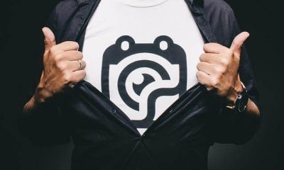 Man holding a custom polo shirt with a company logo