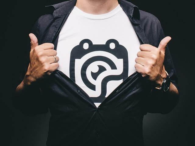 Man holding a custom polo shirt with a company logo