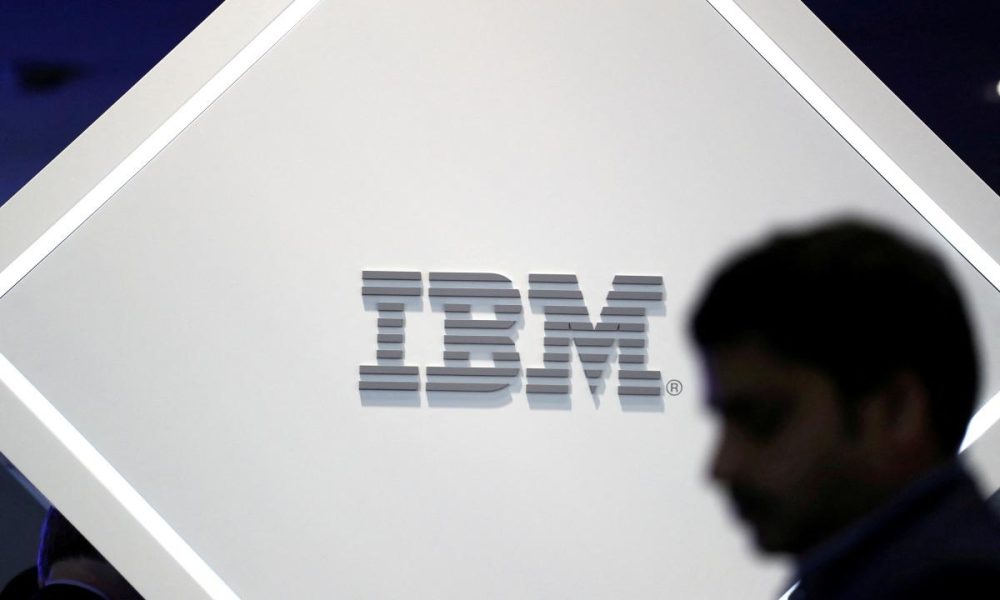 A man stands near an IBM logo at the Mobile World Congress in Barcelona