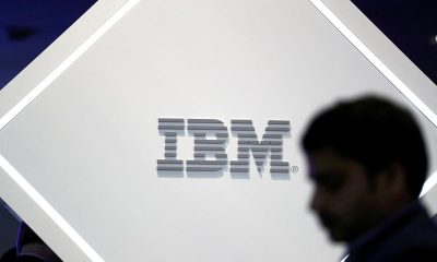 A man stands near an IBM logo at the Mobile World Congress in Barcelona