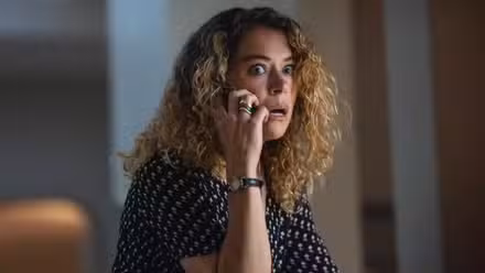 Tatiana Maslany wide-eyed on the phone in Maximum Pleasure Guaranteed 