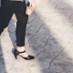 woman walks on cobblestone street; she must be wearing one of our top affordable comfortable heel brands