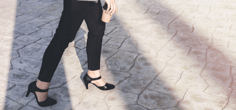 woman walks on cobblestone street; she must be wearing one of our top affordable comfortable heel brands