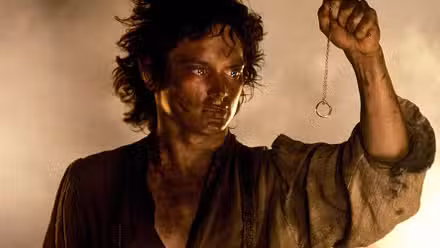 Frodo holds the ring on a chain in Lord of the Rings Return of the King