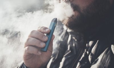 Man,Smokes,New,Vape,Pod,System,,Inhales,And,Exhales,Vapor