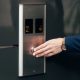woman presses elevator button; she's on her way to a last minute meeting with the CEO or a very important client